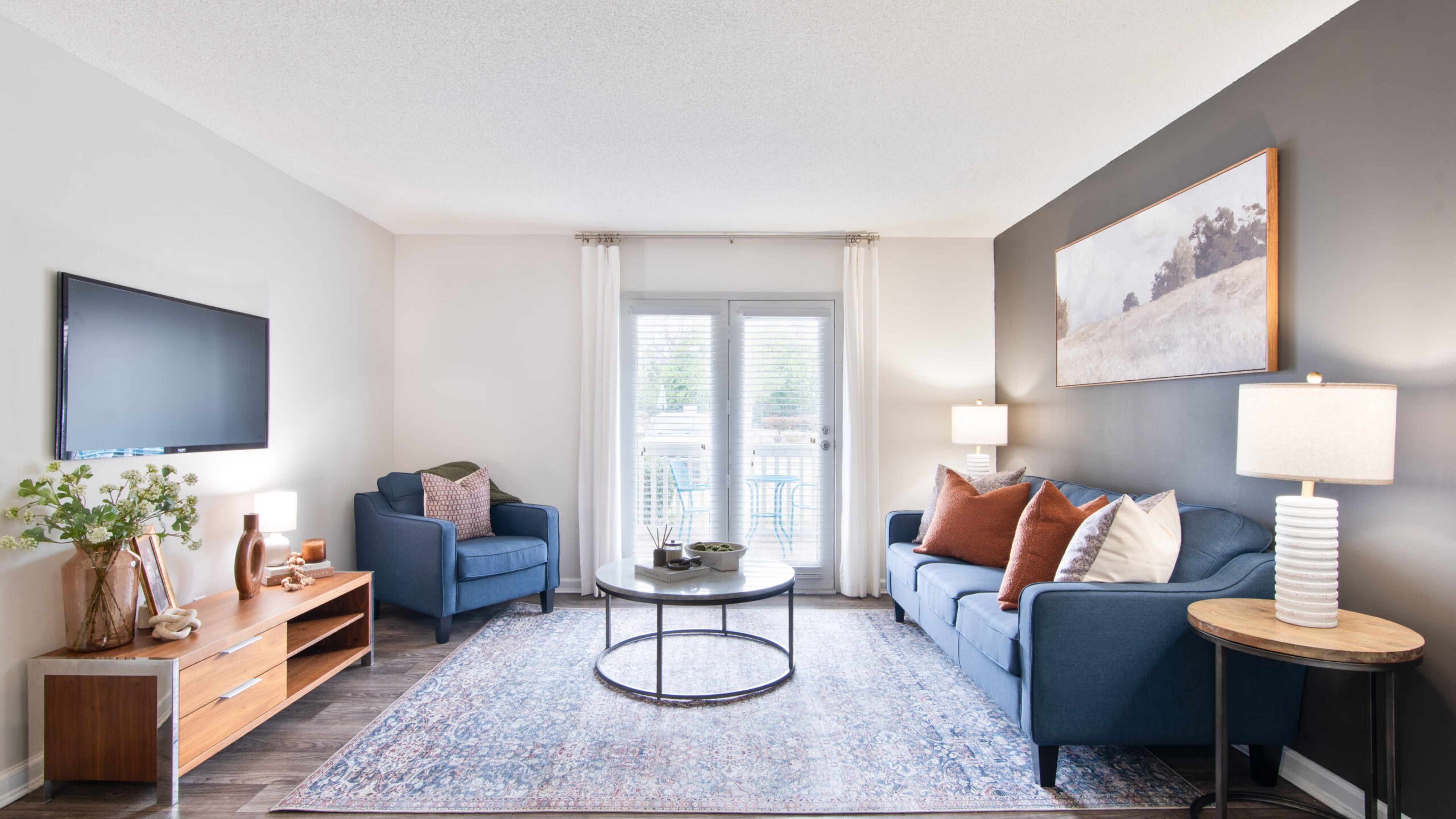 Hawthorne at Lily Flagg apartment living space and kitchen with small dining table, and stainless steel appliances