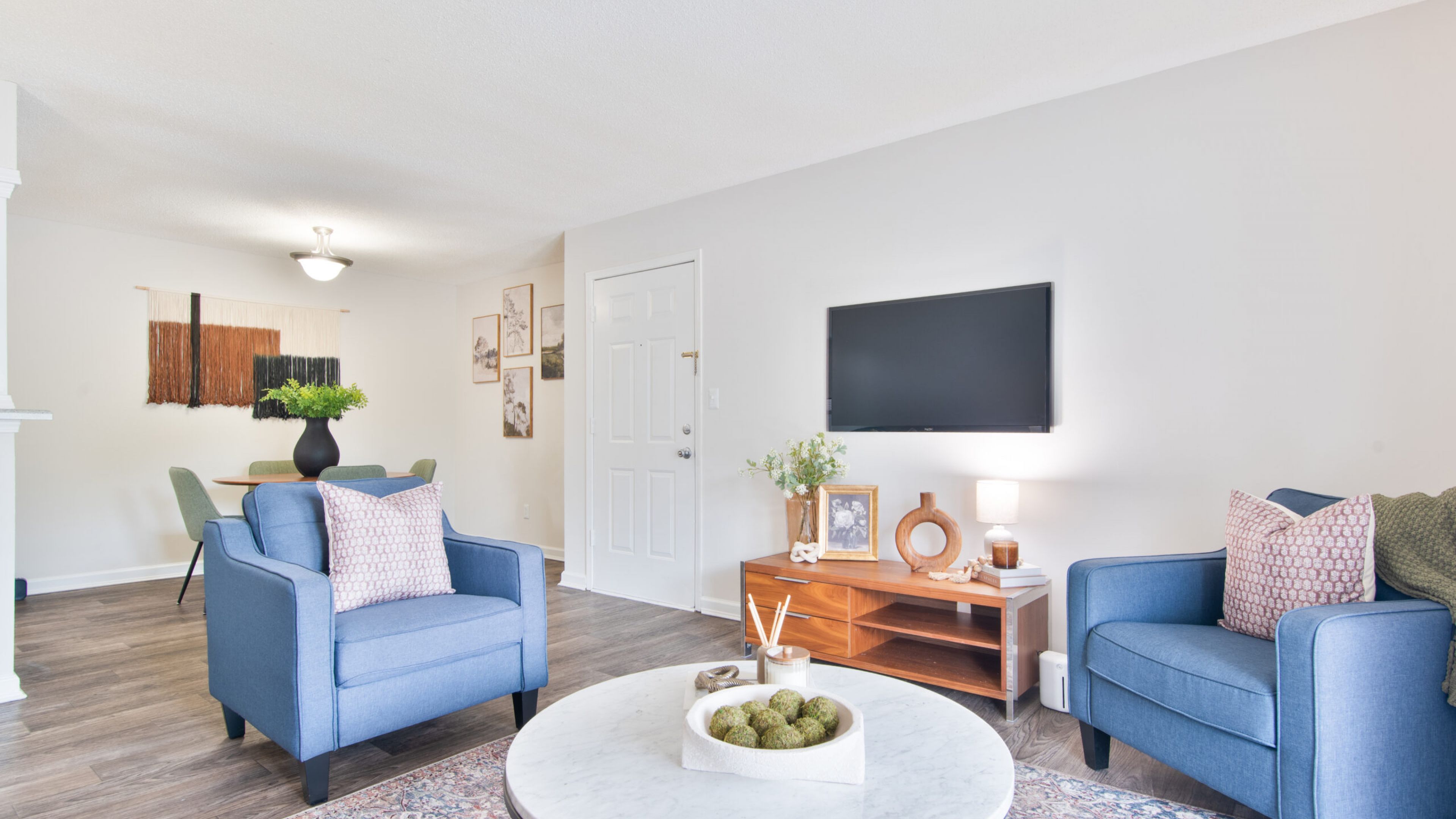 Hawthorne at Lily Flagg apartment living room with large patio doors, furnished with a couch, coffee table, and chairs